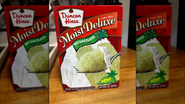 A box of Duncan Hines Moist Deluxe Key Lime Cake Mix on a kitchen counter.