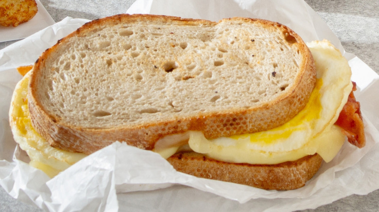 Dunkin' Sourdough Breakfast Sandwich on white paper wrapper