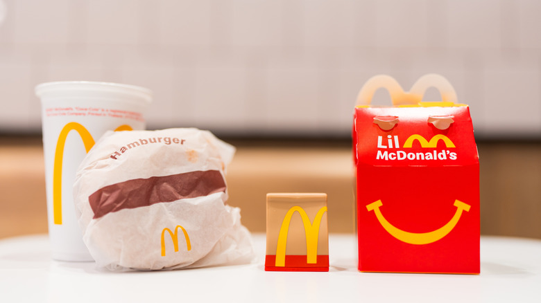 Mcdonald's products in packaging, including a Happy Meal and a Hamburger