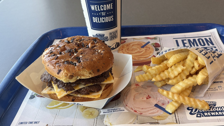 The specialty Colby Jack Burger served at Culver's alongside a drink and French fries.