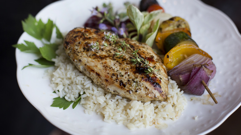 Grilled chicken with rice and vegetable skewer