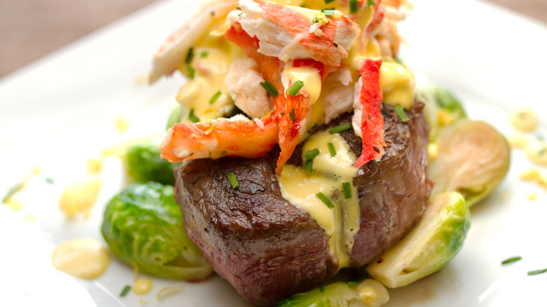 Steak with lobster, hollandaise, and brussel sprouts