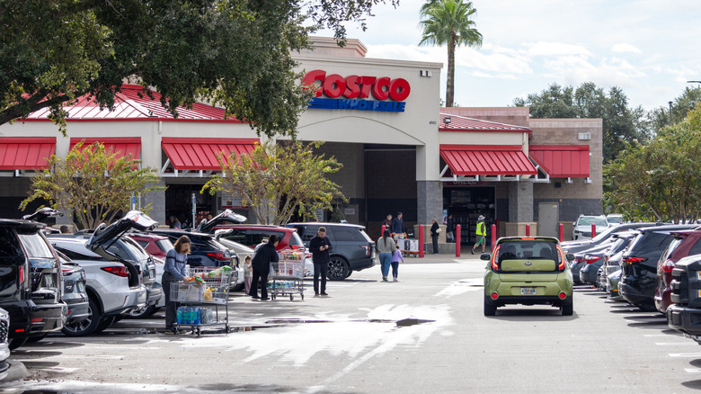 Costco shoppers putting away groceries in parking lot