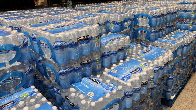Many packs of Kirkland Signature bottled water inside Costco warehouse