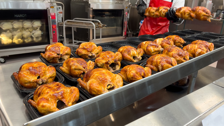 Employee packing cooked Costco rotisserie chickens