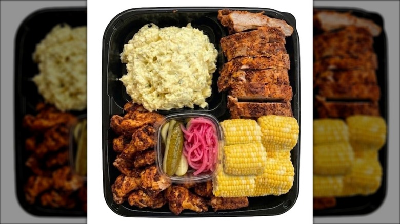 Kirkland Signature Barbecue Platter containing corn, ribs, chicken wings, and potato salad