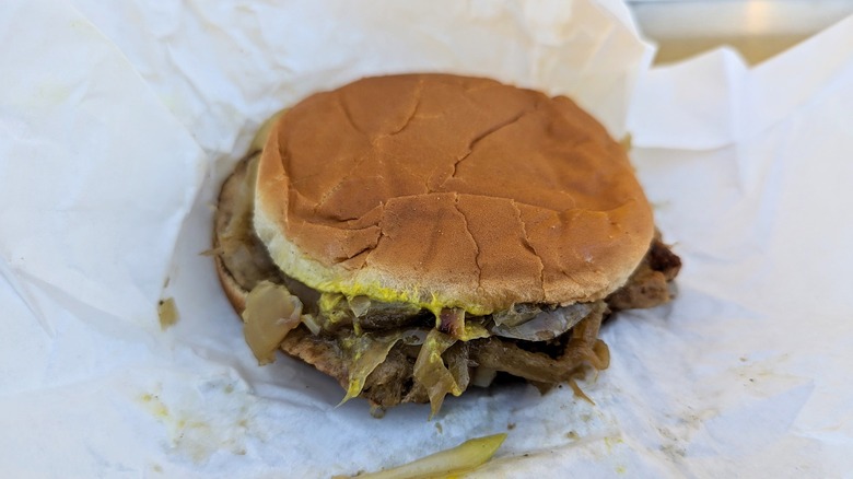 pork chop sandwich with grilled onions and yellow mustard