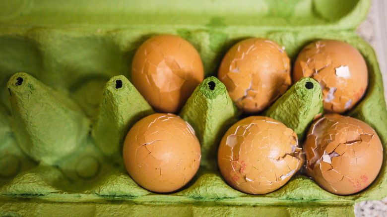 Cracked eggs in a carton