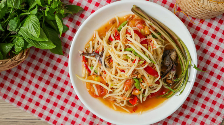 Plate of som tum papaya salad on a checkered cloth