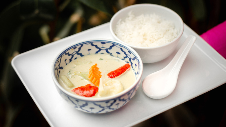 A classic Thai green curry with vegetables in a ceramic bowl