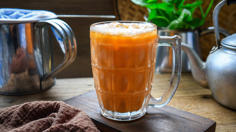 A glass of cha nom yen, Thai iced milk Tea