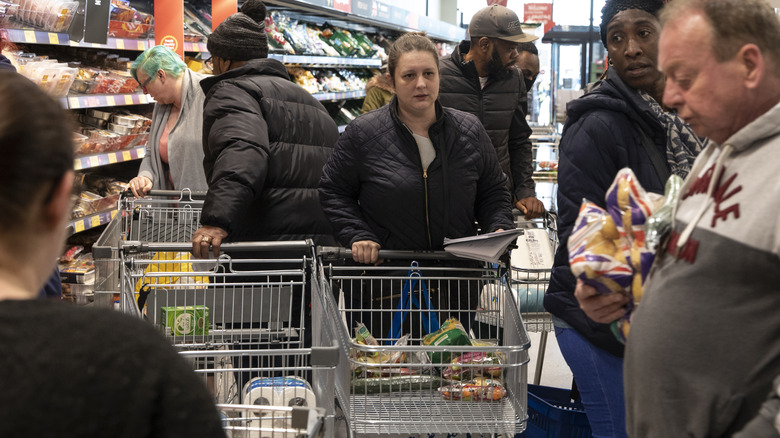 shoppers in the produce section of an Aldi store