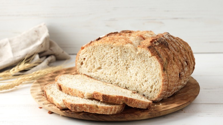 A loaf of sourdough bread with two slices cut from it