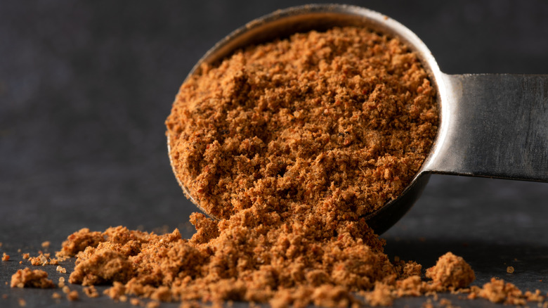 taco seasoning spilling out of a measuring spoon