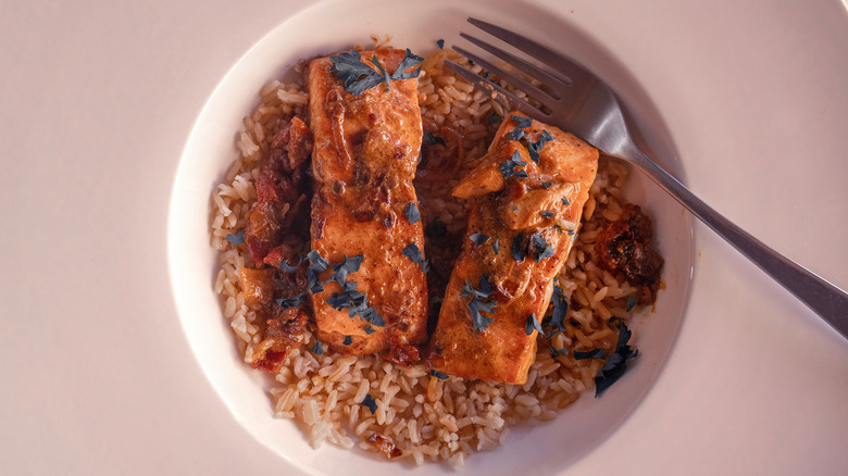 grilled salmon and rice in a white bowl
