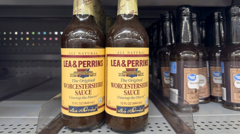 Bottles of Lea & Perrins Worcestershire sauce on store shelves next to great value sauce