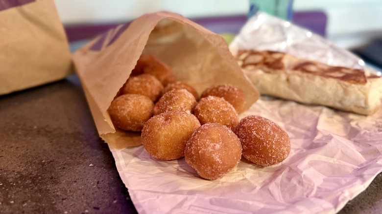 Taco Bell Strawberry Cinnabon Delights in takeout bag on counter