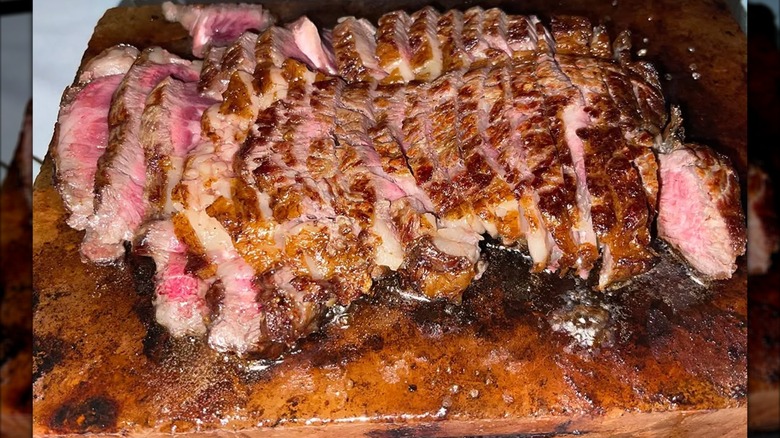 Sliced ribeye arranged on a cutting board. at Fogo de Chão chain restaurant