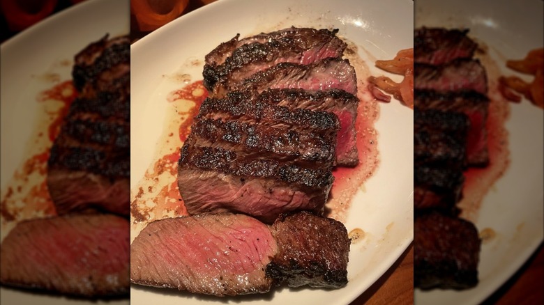 Sliced ribeye steak fanned on a plate at STK steakhouse.