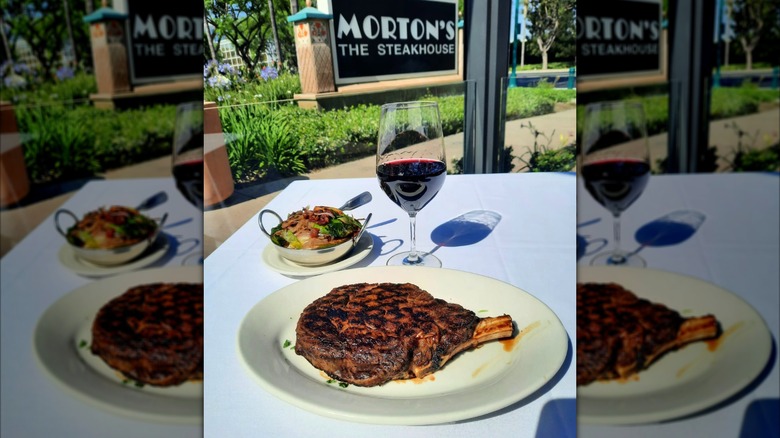 Steak and a glass of wine on a table at Morton's The Steakhouse