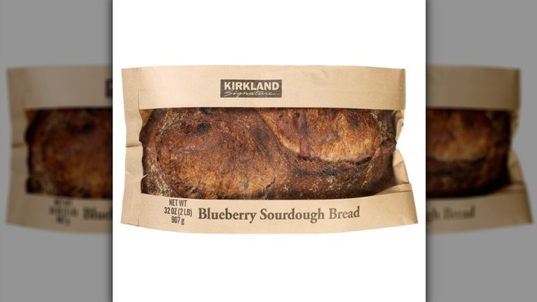 A product image of Costco's Kirkland Signature Blueberry Sourdough Bread on a white background.