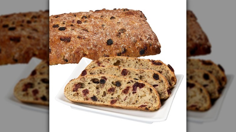 A product image of Costco's Kirkland Signature Cherry Berry Sourdough Bread with Pecans on a white background.