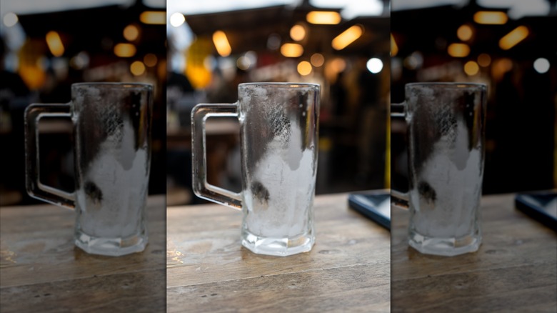 A frosted beer mug in a bar