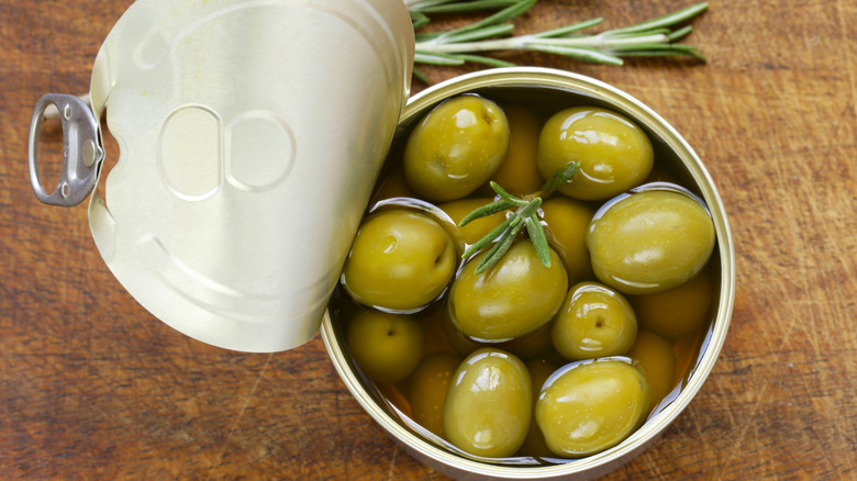 Organic canned green olives with fresh rosemary