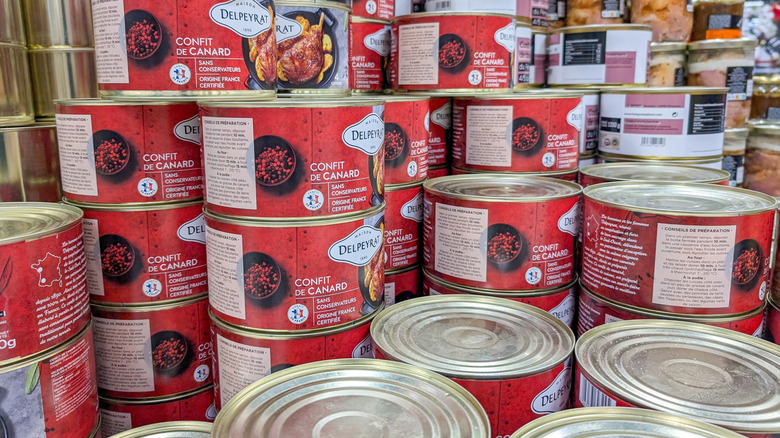Stacks of red and gold tins of Confit de Canard