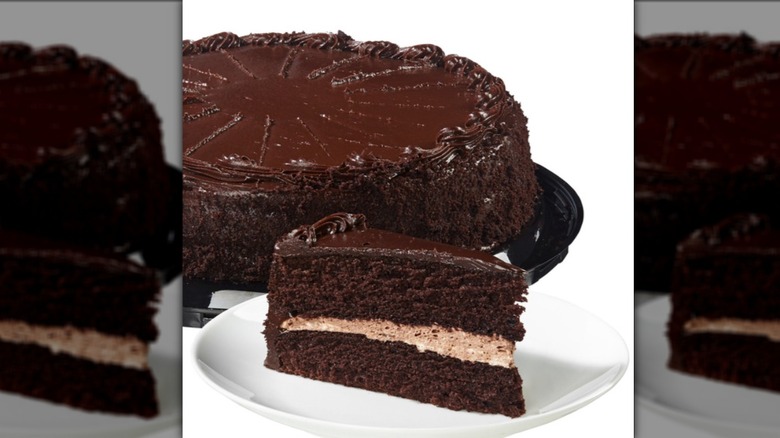 Costco 10" chocolate mousse cake slice on white plate with full cake in the background