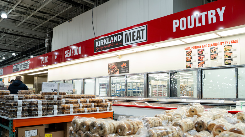 Costco's bakery items on table with poultry and seafood signs