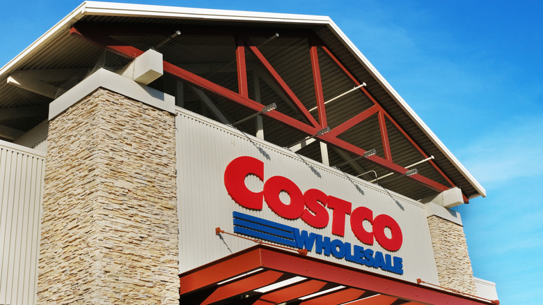 The front sign of a Costco with a pointed roof.