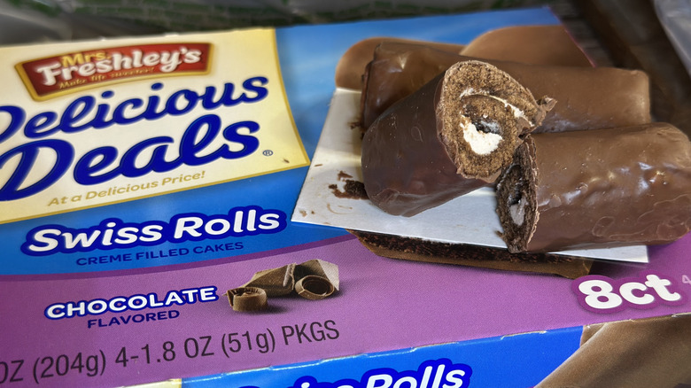 Two Mrs. Freshley's Swiss Rolls on packaging from Dollar Tree; one of the swiss rolls is cut down the middle