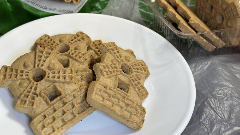 A stack of Lil' Dutch Almond Windmill Cookies from Dollar Tree on a white plate