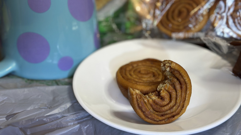 Two Mrs. Freshley's Pecan Twirls from Dollar Tree on a white dish; one with a bite out of it