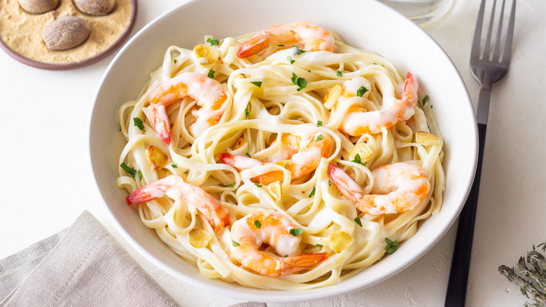 White bowl of creamy shrimp pasta