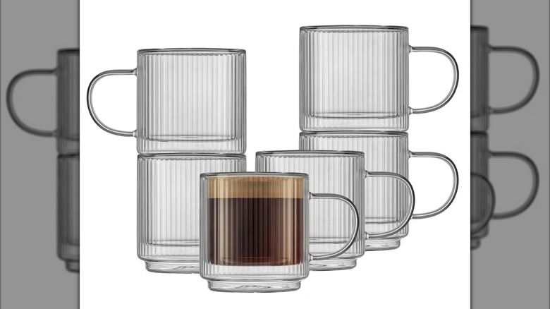 The JoyJolt Glass Mugs sold at Costco stacked on top of one another, one of which has coffee in it.