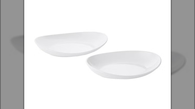 Two white Baum stoneware platters included in the serving set from Costco on a white background.