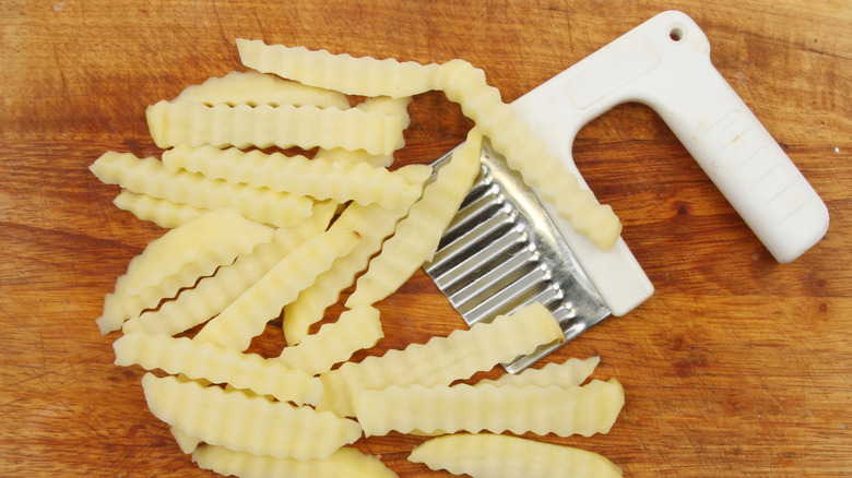 Wavy potato sticks shaped using a manual crinkle cutter