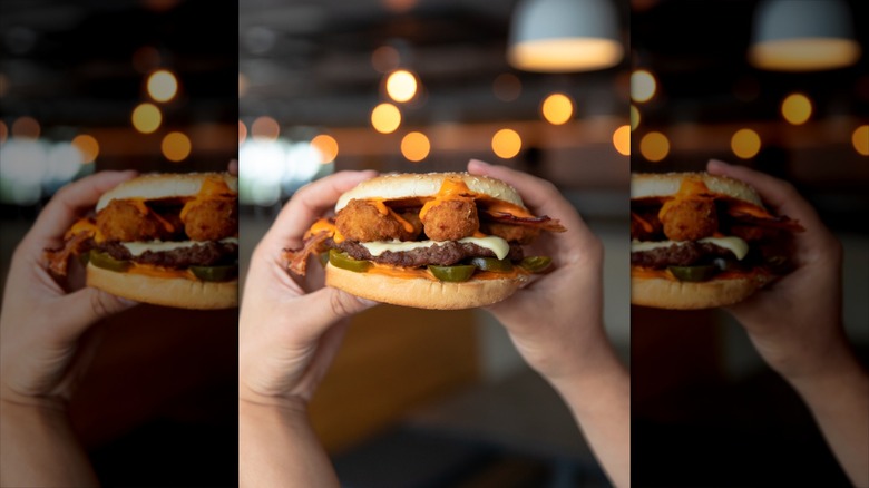 Hands holding El Diablo burger