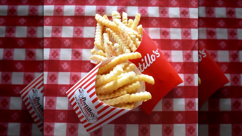 Two boxes of crinkle fries on red gingham tablecloth