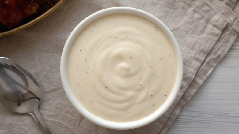 A bowl of homemade Alabama white BBQ sauce.