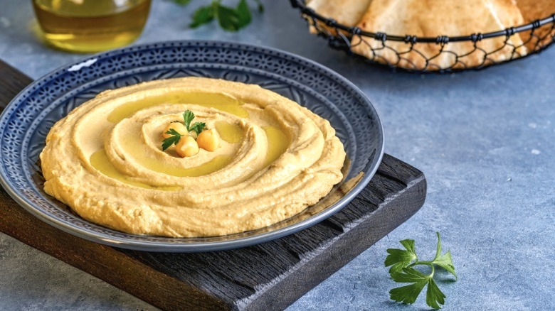 Hummus served in a blue bowl.