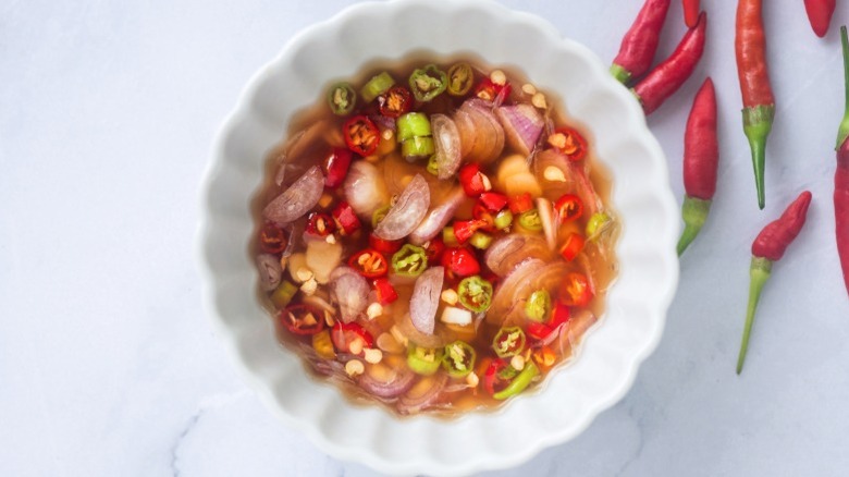 A white bowl of prik nam pla.