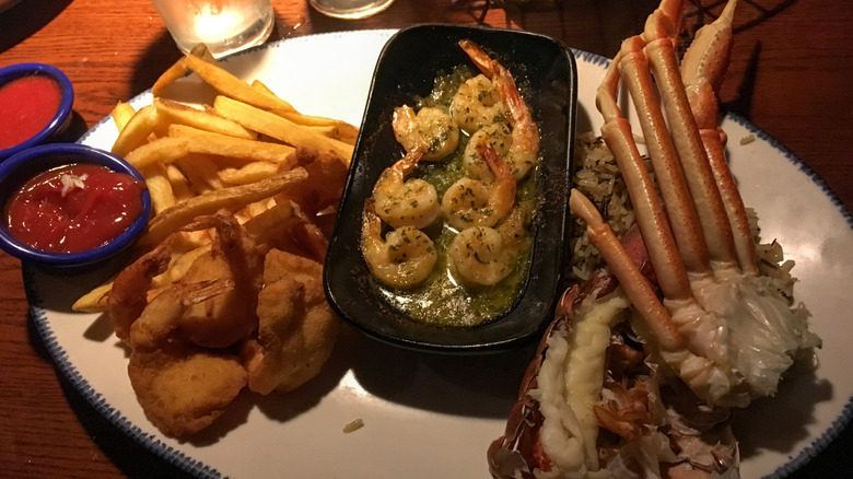 Plate of shrimp, crab and French fries on a plate at Red Lobster