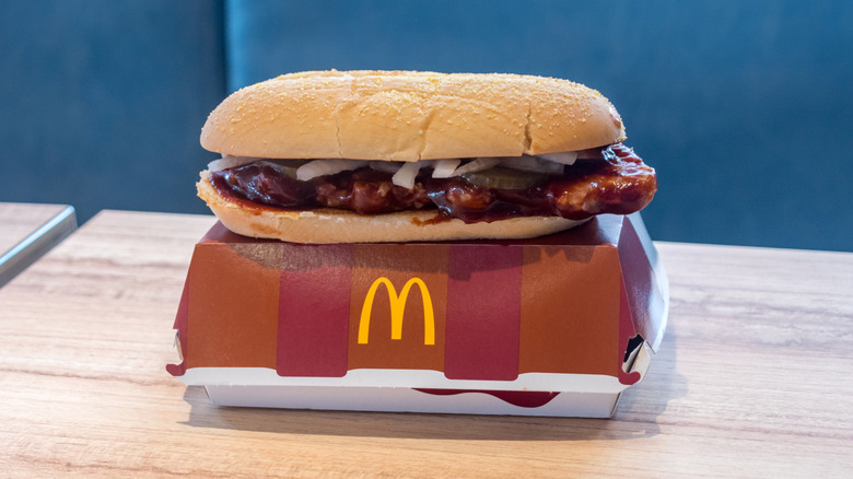 The McRib sandwich from McDonald's on top of its cardboard container