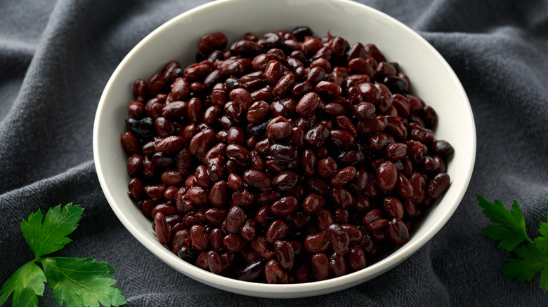 A white bowl filled with canned black beans
