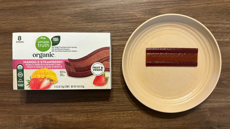 Simple Truth Organic Strawberry Mango Strips package and mango fruit strip on plate