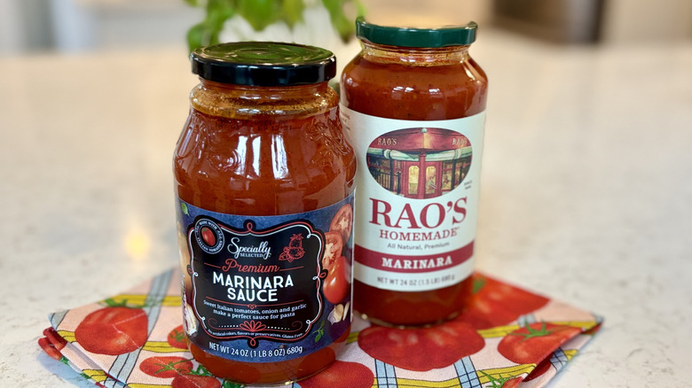 A jar of Aldi Specially Selected marinara sauce next to Rao's marinara sauce