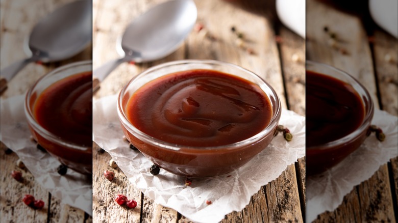 Bowl of barbecue sauce on table with a spoon